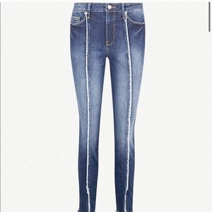 Good American raw hem skinny jean cropped jeans.